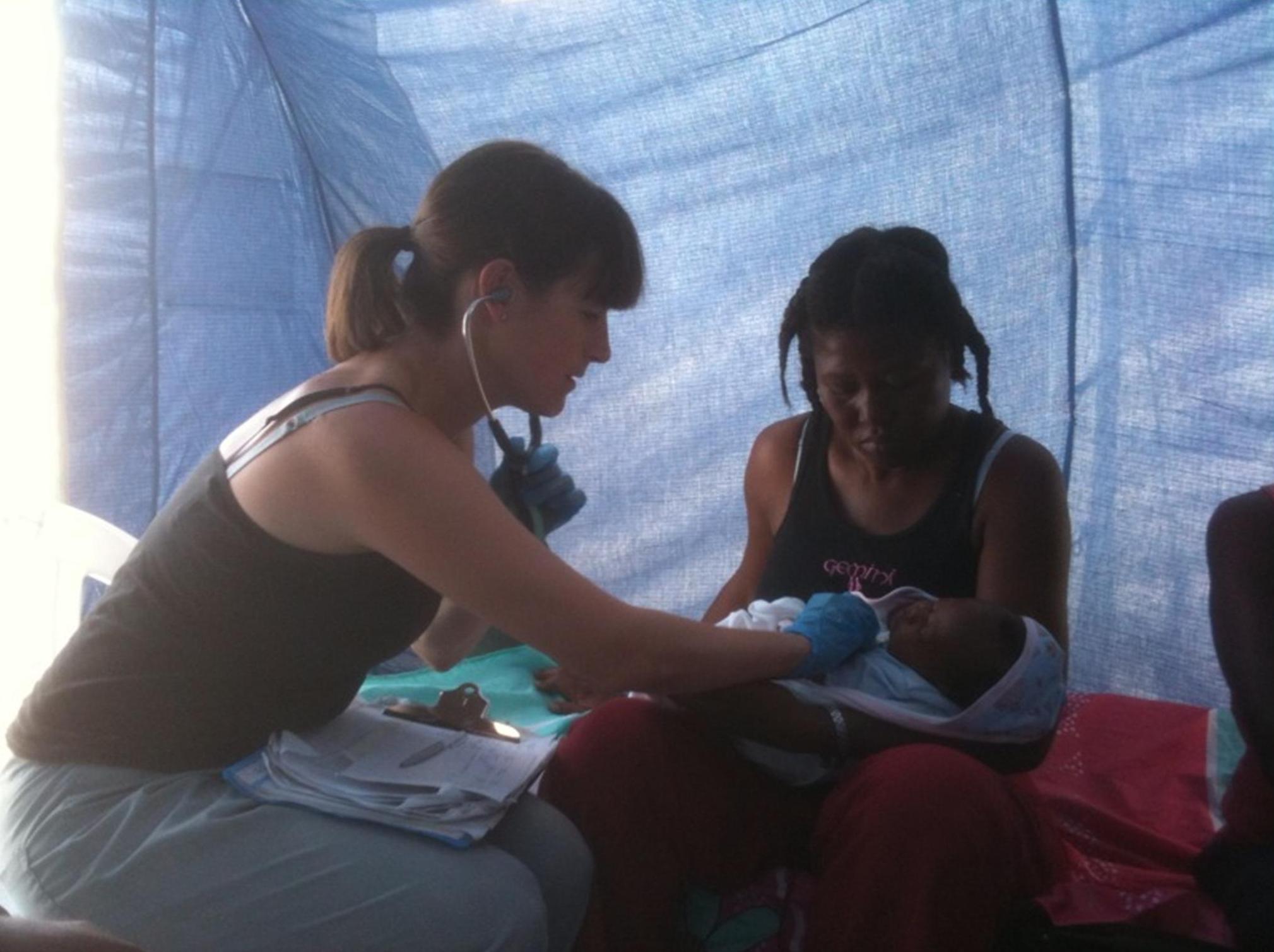 <em><strong>Gillian Morantz with a patient in the clinic<p>at the nearby internally displaced persons camp. Photo courtesy Gillian Morantz.</em></strong>