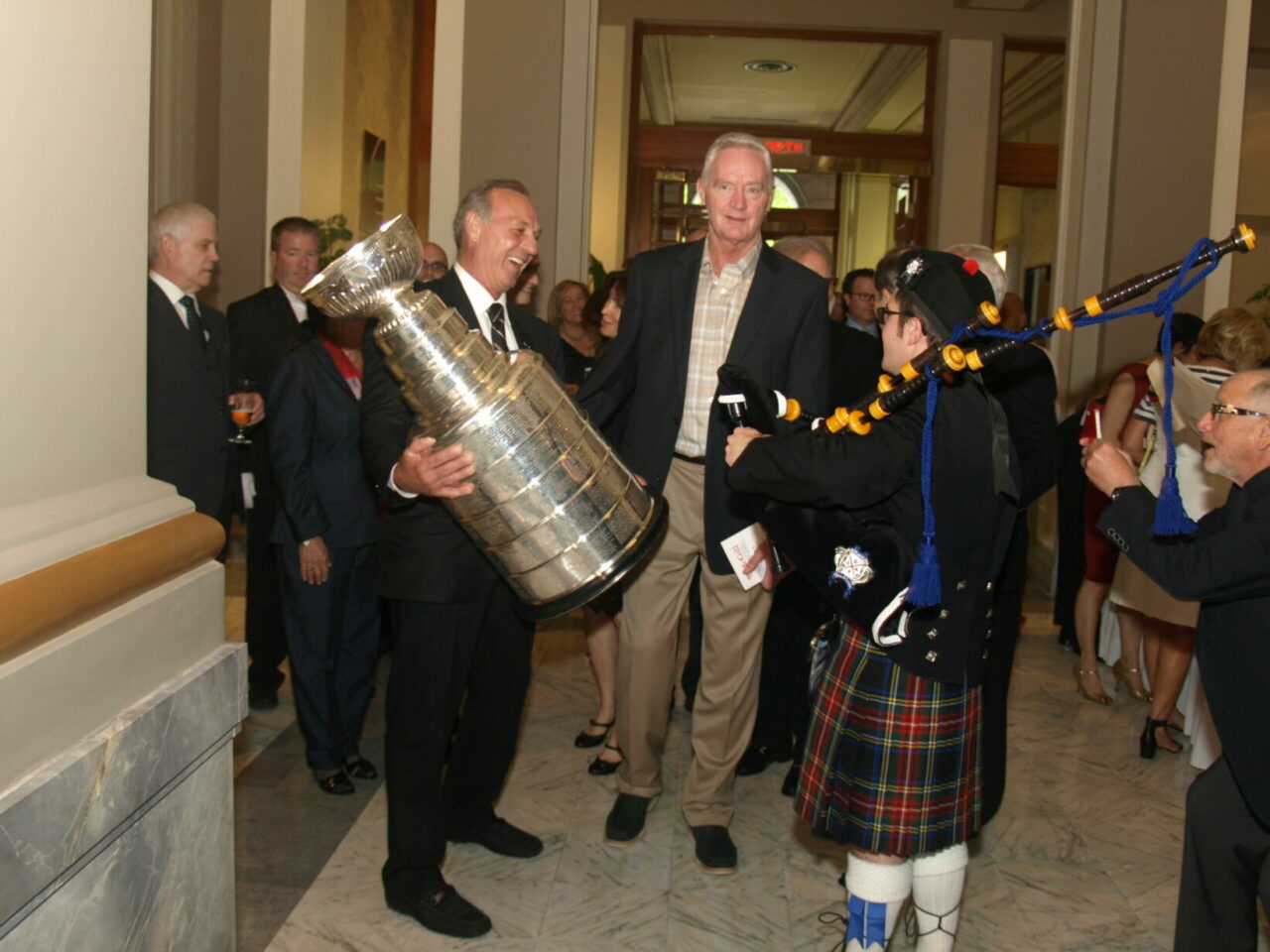 Stanley cup procession - bagpiper Jeremy Farber-Tetrault (Michael Farber's son). Guy Lafleur carrying the cup accompanied by Larry Robinson (Photo: Jack Gurevitch)