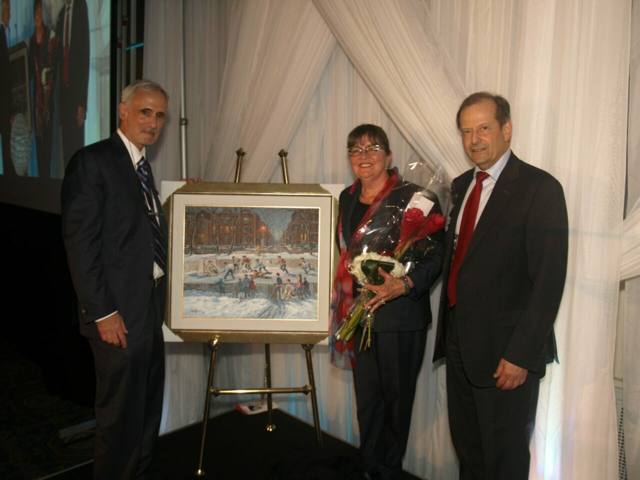 Michael Farber and wife, Danielle Farber-Tetrault being presented with a Ravery painting by Dr. Frenkiel (Photo: Jack Gurevitch)