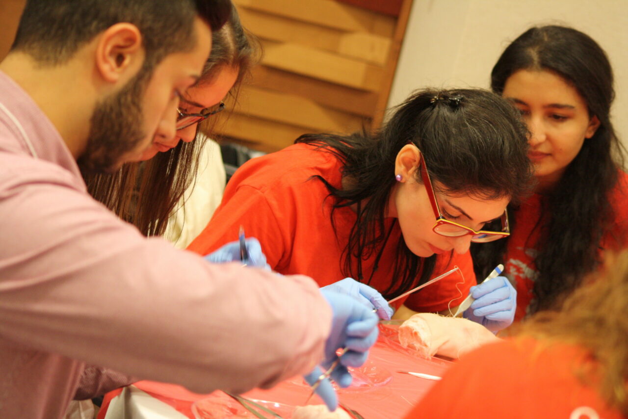 Student practicing her suturing skills on a pig’s foot.  (Photo: Annelise Miller)